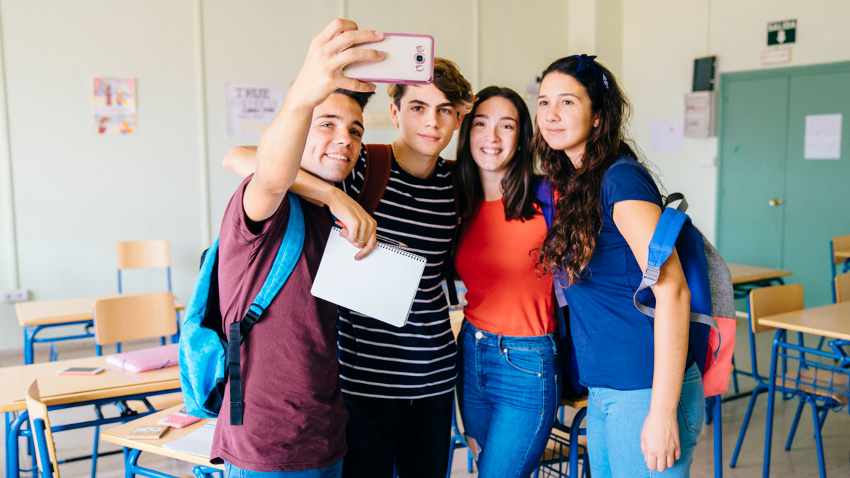 group-friends-taking-selfie-classroom